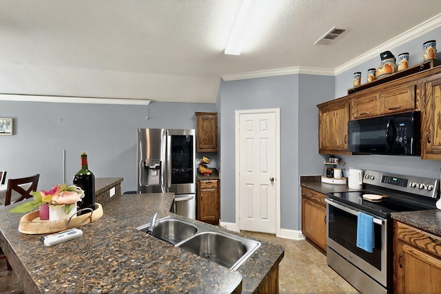 2715 Myopia Ct, Dallas, TX 75253 - kitchen featuring stainless steel appliances, a sink, dark countertops, a kitchen island with sink, and brown cabinets