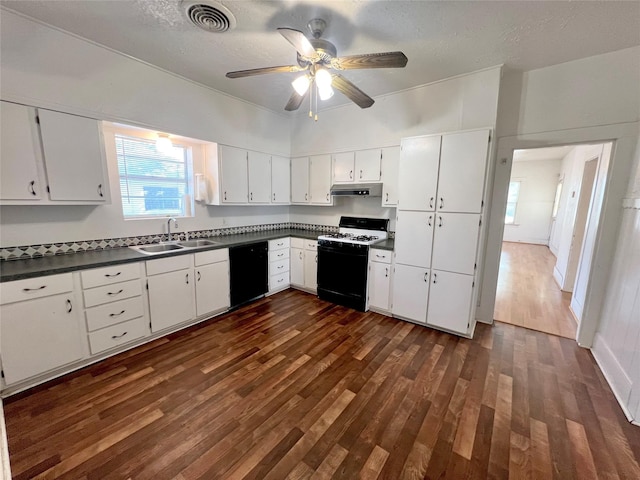 1801 6th St, Brownwood, TX 76801 - kitchen featuring gas stove, a sink, black dishwasher, dark countertops, and dark wood-style flooring