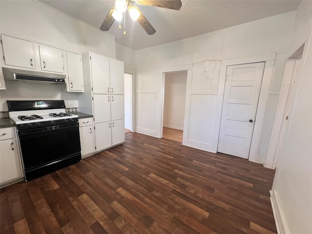 1801 6th St, Brownwood, TX 76801 - kitchen featuring gas range oven, under cabinet range hood, dark wood-type flooring, and white cabinets