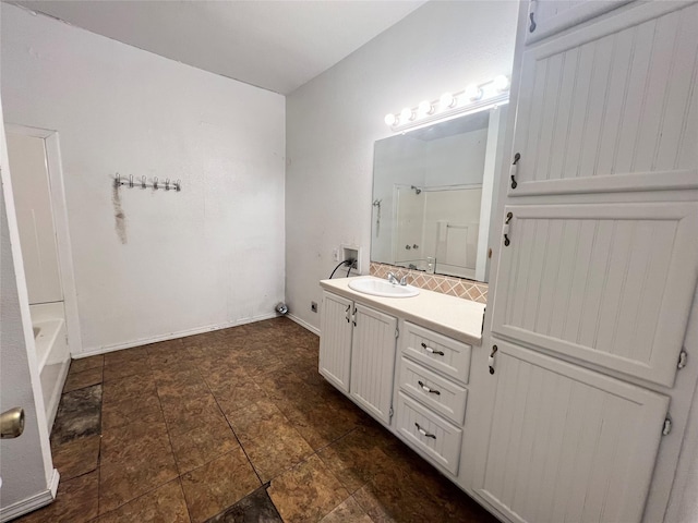 1801 6th St, Brownwood, TX 76801 - bathroom featuring a shower, vanity, a bathtub, tasteful backsplash, and stone finish floors