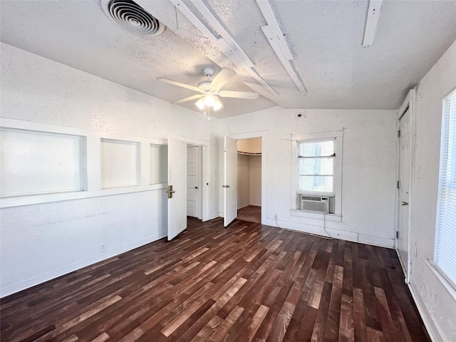 1801 6th St, Brownwood, TX 76801 - unfurnished bedroom featuring wood finished floors, lofted ceiling, cooling unit, a ceiling fan, and a textured wall