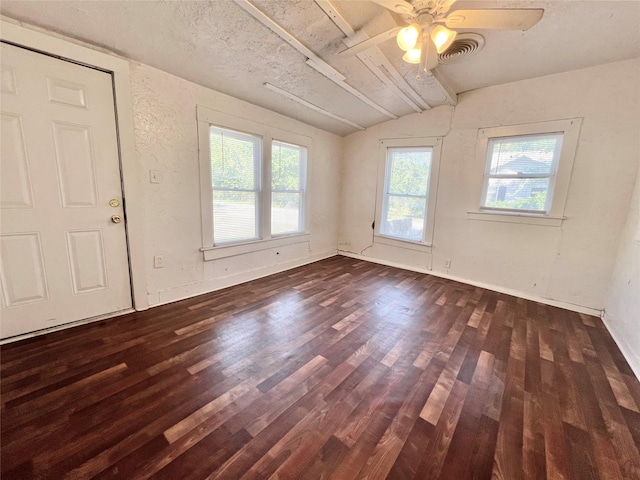 1801 6th St, Brownwood, TX 76801 - empty room featuring lofted ceiling, dark wood-type flooring, and a ceiling fan