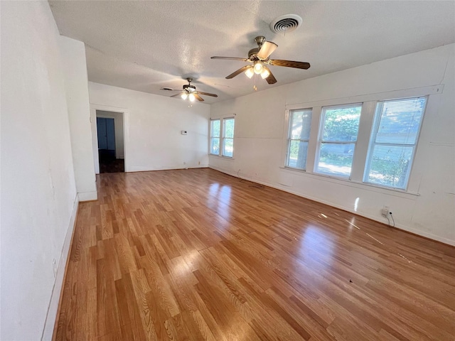 1801 6th St, Brownwood, TX 76801 - spare room featuring light wood-type flooring, a ceiling fan, baseboards, and a textured ceiling