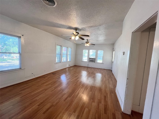 1801 6th St, Brownwood, TX 76801 - unfurnished room with a textured ceiling, ceiling fan, wood finished floors, and baseboards