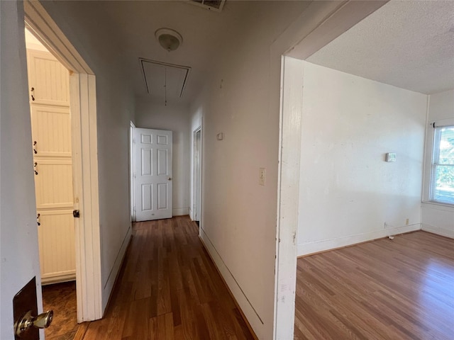 1801 6th St, Brownwood, TX 76801 - hallway with attic access, wood finished floors, and baseboards
