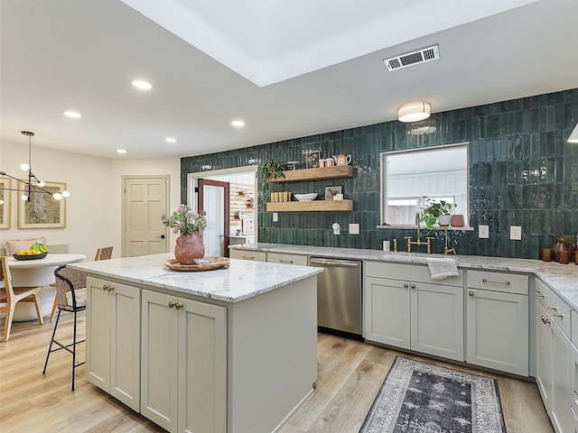 6512 Elkhurst Dr, Plano, TX 75023 - kitchen featuring stainless steel dishwasher, a sink, a kitchen island, light wood finished floors, and a chandelier