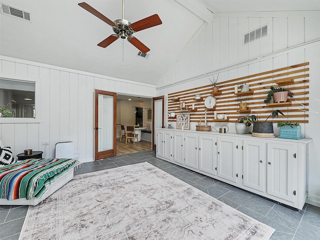 6512 Elkhurst Dr, Plano, TX 75023 - living room with ceiling fan, dark tile patterned floors, high vaulted ceiling, wooden walls, and beam ceiling