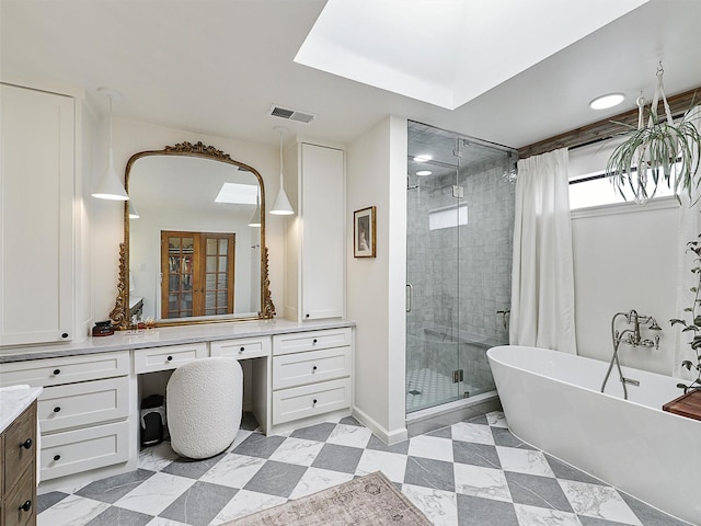 6512 Elkhurst Dr, Plano, TX 75023 - full bath featuring a shower stall, vanity, a freestanding tub, and baseboards