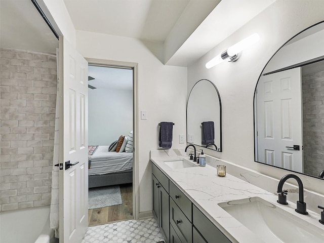 6512 Elkhurst Dr, Plano, TX 75023 - full bathroom with tile patterned floors, double vanity, ensuite bath, and shower / bathtub combination