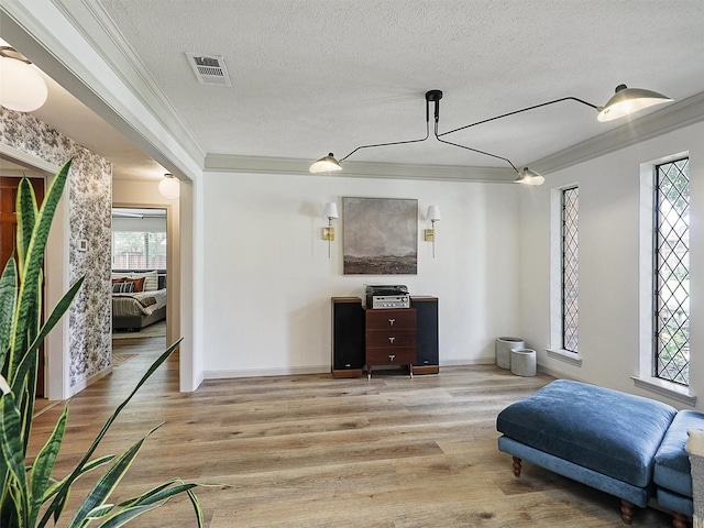 6512 Elkhurst Dr, Plano, TX 75023 - living area with crown molding, a textured ceiling, wood finished floors, and baseboards