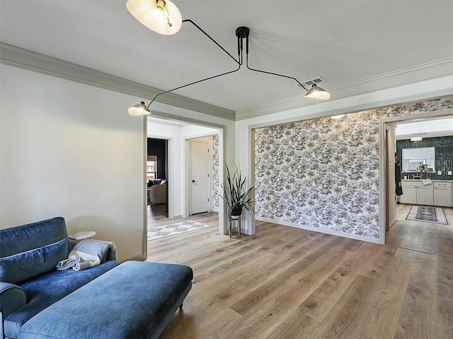 6512 Elkhurst Dr, Plano, TX 75023 - living area with light wood-type flooring, crown molding, a textured ceiling, and baseboards