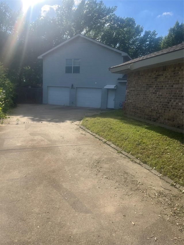 1212 Oakwood Trl, Southlake, TX 76092 - view of property exterior featuring an attached garage, driveway, brick siding, and a yard