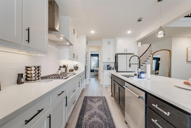 1308 Redbrick Ln, Northlake, TX 76247 - kitchen featuring appliances with stainless steel finishes, wall chimney range hood, white cabinets, decorative light fixtures, and recessed lighting