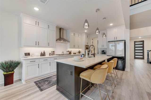 1308 Redbrick Ln, Northlake, TX 76247 - kitchen featuring wall chimney exhaust hood, a breakfast bar, light countertops, white cabinetry, and recessed lighting