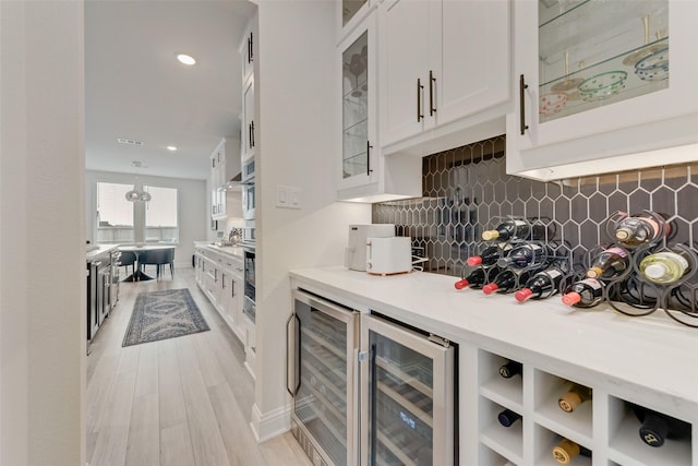 1308 Redbrick Ln, Northlake, TX 76247 - bar area with wine cooler, backsplash, light wood finished floors, recessed lighting, and oven