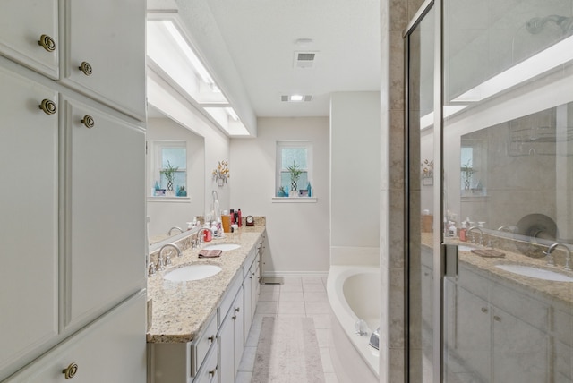 154 Scott Ln, Weatherford, TX 76085 - full bath with double vanity, tile patterned floors, a garden tub, and a shower stall