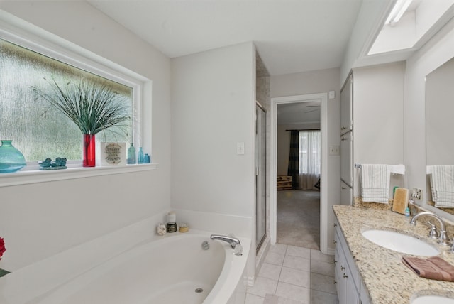 154 Scott Ln, Weatherford, TX 76085 - full bath featuring tile patterned floors, double vanity, a garden tub, and a shower stall