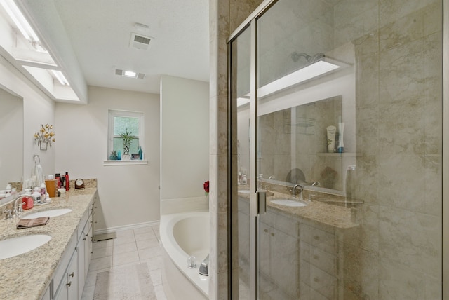 154 Scott Ln, Weatherford, TX 76085 - full bath with double vanity, a garden tub, a shower stall, and tile patterned flooring