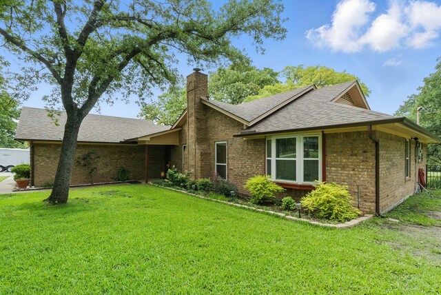 154 Scott Ln, Weatherford, TX 76085 - view of front of house featuring brick siding, a front yard, a chimney, and a shingled roof