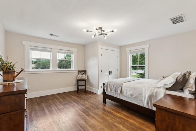 3718 Tulsa Way, Fort Worth, TX 76107 - bedroom featuring dark wood-style floors, baseboards, and a chandelier