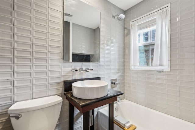 3718 Tulsa Way, Fort Worth, TX 76107 - full bath featuring tile walls, toilet, decorative backsplash, a sink, and shower / bathtub combination