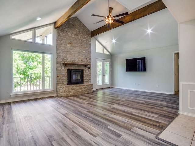 7710 Ravenswood Rd, Granbury, TX 76049 - unfurnished living room with wood finished floors, ceiling fan, a stone fireplace, french doors, and baseboards