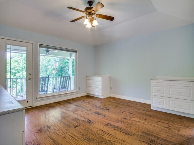 7710 Ravenswood Rd, Granbury, TX 76049 - empty room with a ceiling fan, wood finished floors, and baseboards