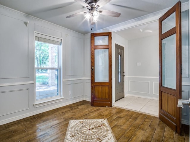 7710 Ravenswood Rd, Granbury, TX 76049 - entryway with a decorative wall, wood finished floors, ornamental molding, and a ceiling fan