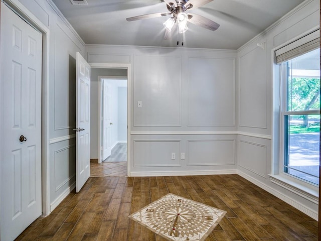 7710 Ravenswood Rd, Granbury, TX 76049 - spare room featuring a decorative wall, dark wood-type flooring, a ceiling fan, and ornamental molding
