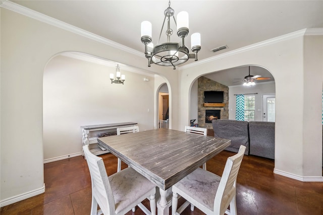 14125 Lone Pne, Brownsboro, TX 75756 - dining area with a chandelier, arched walkways, a fireplace, ornamental molding, and baseboards