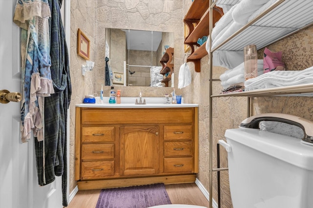 1006 Beaver St, Lacy Lakeview, TX 76705 - bathroom featuring wood finished floors, vanity, toilet, and baseboards