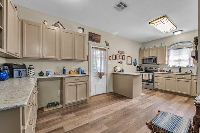1006 Beaver St, Lacy Lakeview, TX 76705 - kitchen with appliances with stainless steel finishes and light wood-style flooring