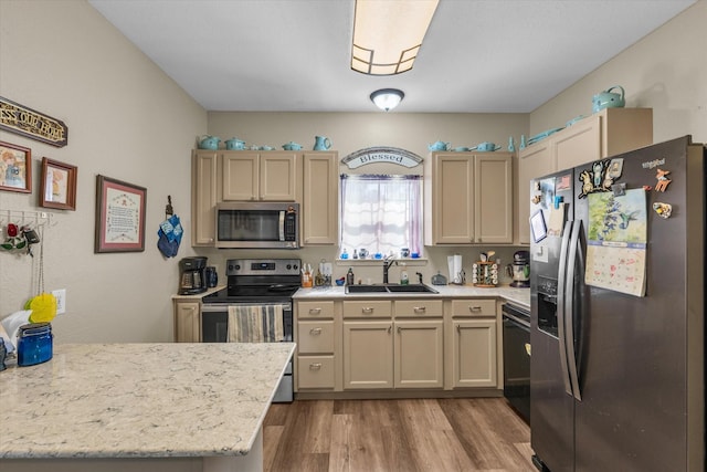 1006 Beaver St, Lacy Lakeview, TX 76705 - kitchen with appliances with stainless steel finishes, a sink, light wood-style flooring, a peninsula, and light stone counters