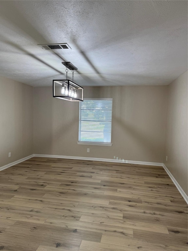711 S Farmington Rd, Howe, TX 75459 - empty room featuring a textured ceiling, wood finished floors, and baseboards