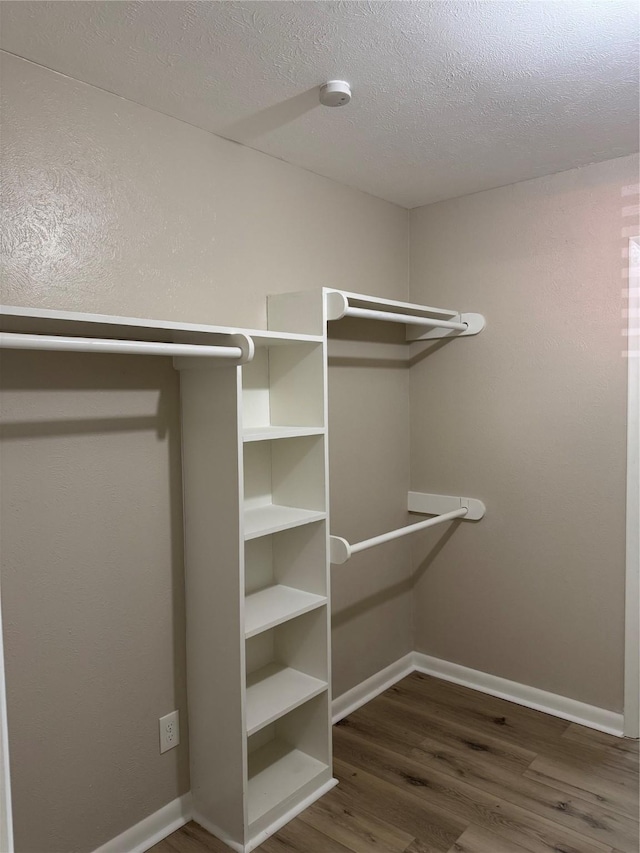 711 S Farmington Rd, Howe, TX 75459 - spacious closet featuring dark wood finished floors