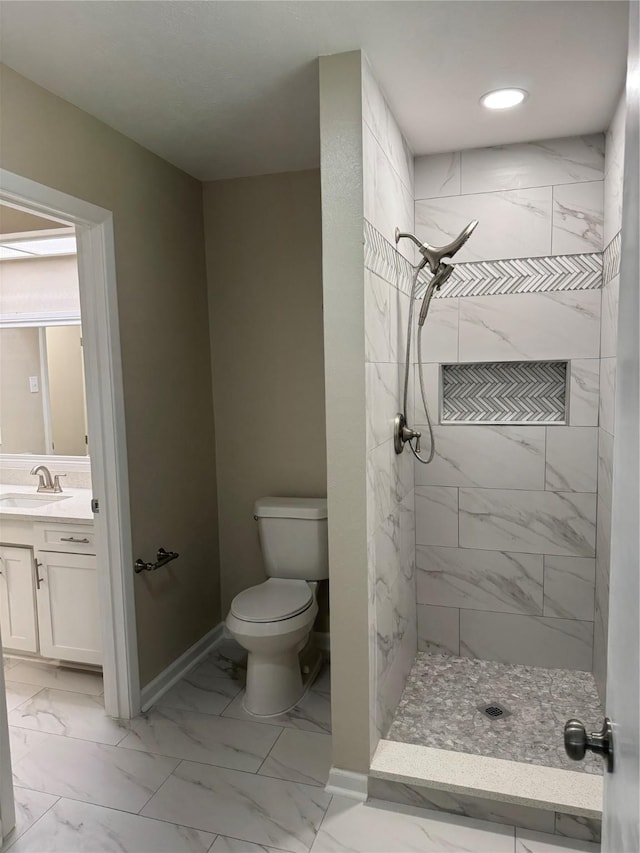711 S Farmington Rd, Howe, TX 75459 - bathroom featuring toilet, tiled shower, marble finish floors, vanity, and baseboards