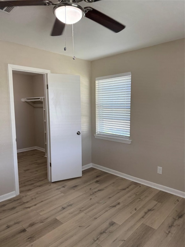 711 S Farmington Rd, Howe, TX 75459 - unfurnished bedroom featuring light wood-type flooring, a spacious closet, baseboards, and a closet