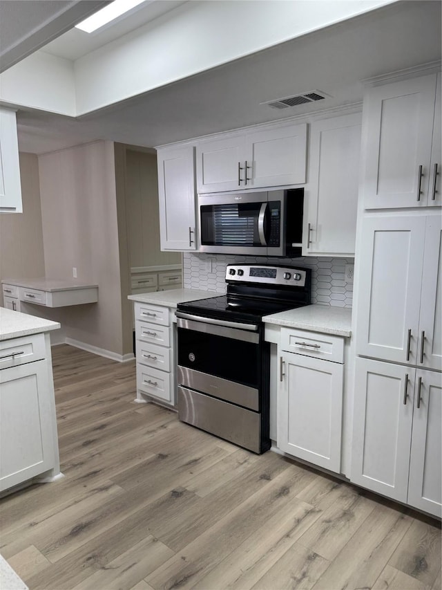 711 S Farmington Rd, Howe, TX 75459 - kitchen with appliances with stainless steel finishes, tasteful backsplash, light countertops, and light wood-style flooring