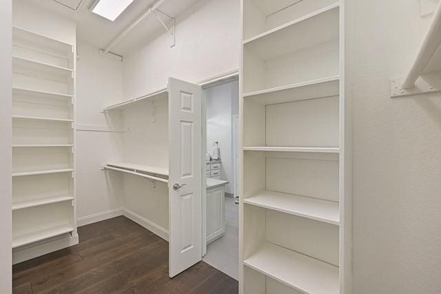 711 Saratoga Dr, Southlake, TX 76092 - walk in closet with dark wood-style flooring