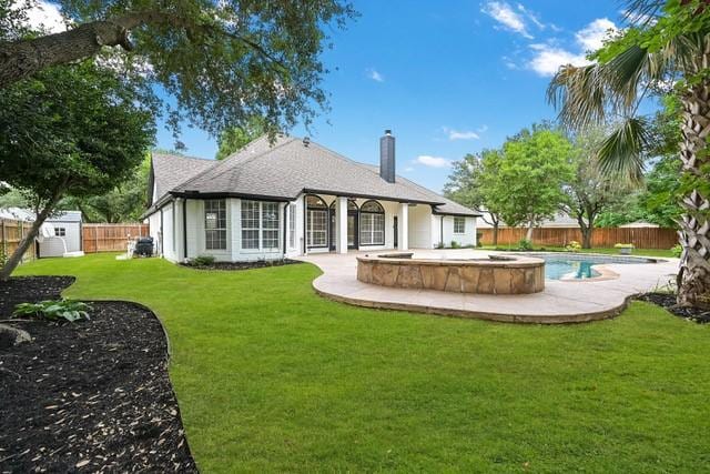 711 Saratoga Dr, Southlake, TX 76092 - rear view of house with a chimney, a patio area, and a pool with connected hot tub