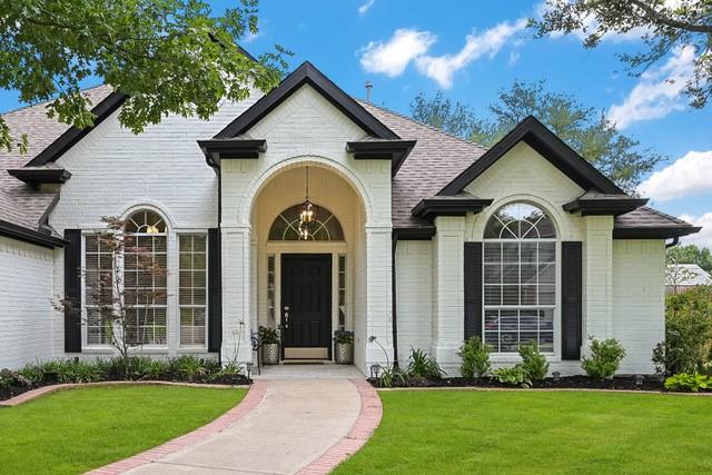 711 Saratoga Dr, Southlake, TX 76092 - view of front of property with a front yard, brick siding, and roof with shingles