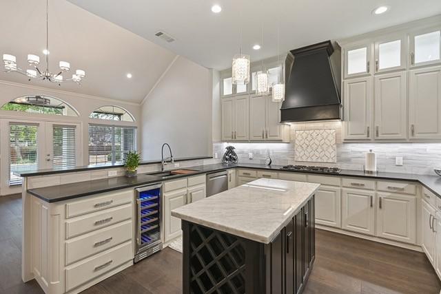 711 Saratoga Dr, Southlake, TX 76092 - kitchen with beverage cooler, custom range hood, a sink, stainless steel dishwasher, and a peninsula