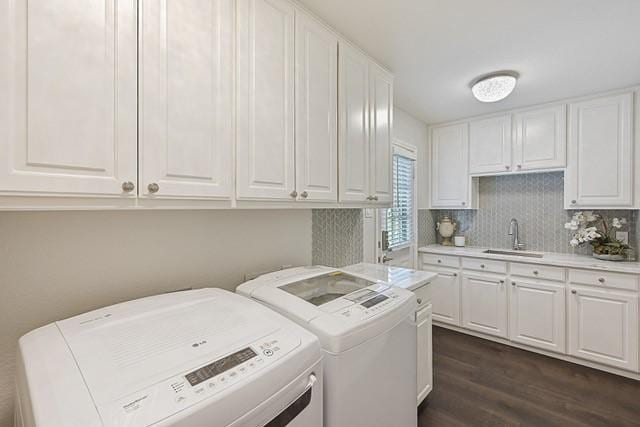711 Saratoga Dr, Southlake, TX 76092 - laundry area featuring washer and clothes dryer, dark wood finished floors, and cabinet space