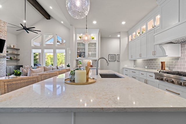 410 Travelers Ter, Argyle, TX 76226 - kitchen featuring a sink, stainless steel gas stovetop, decorative backsplash, white cabinetry, and beam ceiling