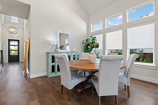 410 Travelers Ter, Argyle, TX 76226 - dining area with high vaulted ceiling, dark wood-style floors, baseboards, and a chandelier