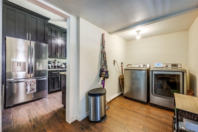 101 E Mulberry St, Decatur, TX 76234 - laundry area with separate washer and dryer, wood finished floors, and baseboards
