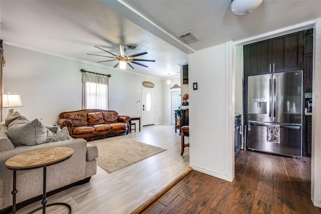 101 E Mulberry St, Decatur, TX 76234 - living room with ornamental molding, dark wood-style floors, ceiling fan, and baseboards
