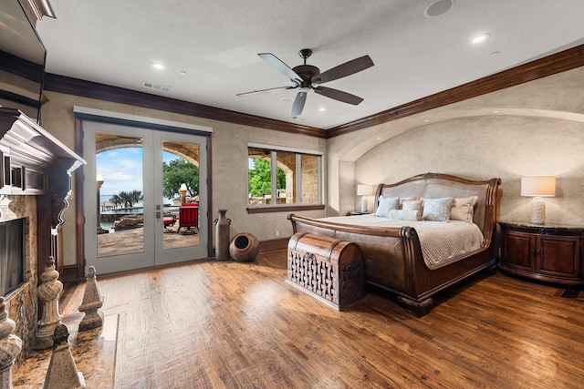 1612 S Lakeshore Dr, Rockwall, TX 75087 - bedroom featuring french doors, wood finished floors, access to exterior, crown molding, and a premium fireplace