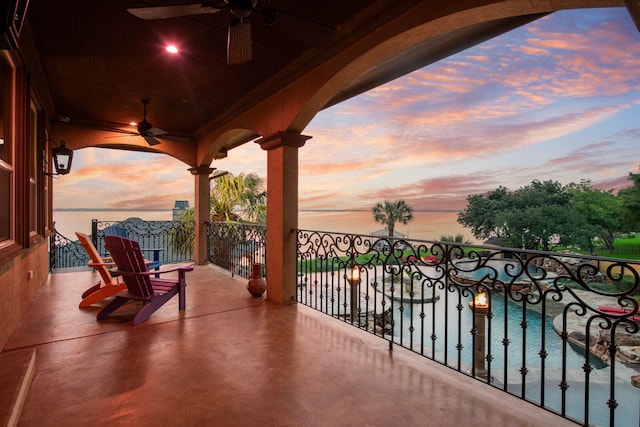 1612 S Lakeshore Dr, Rockwall, TX 75087 - balcony at dusk featuring ceiling fan and view of pool area