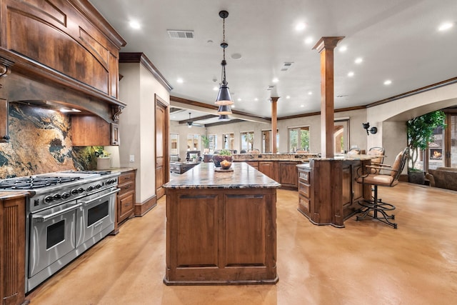 1612 S Lakeshore Dr, Rockwall, TX 75087 - kitchen with range with two ovens, ornamental molding, a spacious island, concrete floors, and recessed lighting